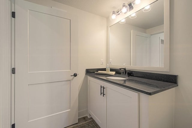 bathroom featuring vanity and a textured ceiling