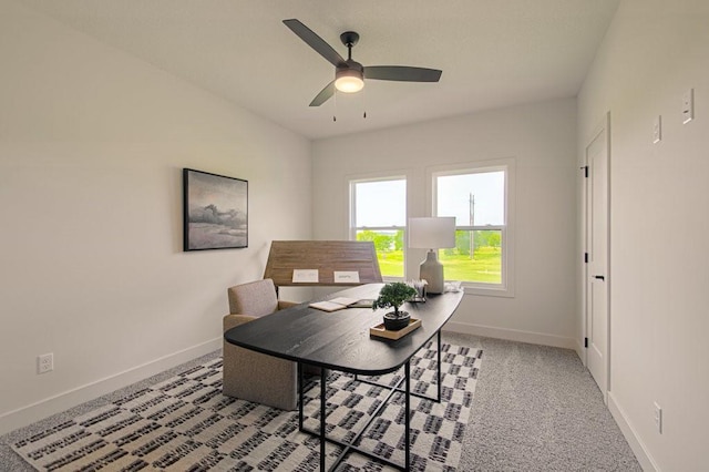 office area featuring a ceiling fan and baseboards