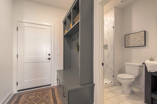 full bathroom with toilet, a stall shower, baseboards, and vanity