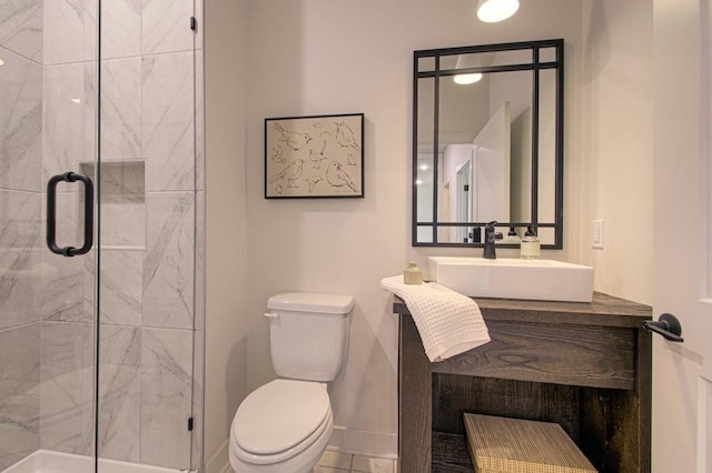 full bath with vanity, a shower stall, toilet, and baseboards