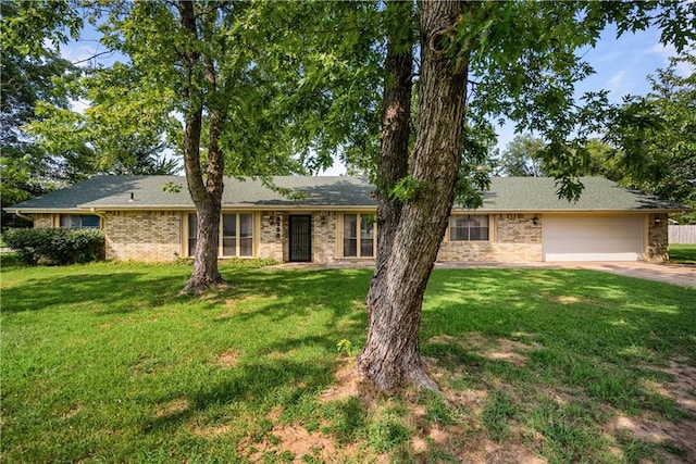 single story home featuring a garage and a front yard