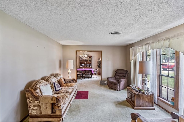 carpeted living room featuring a textured ceiling