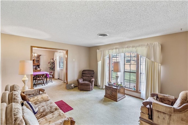 carpeted living room with a textured ceiling