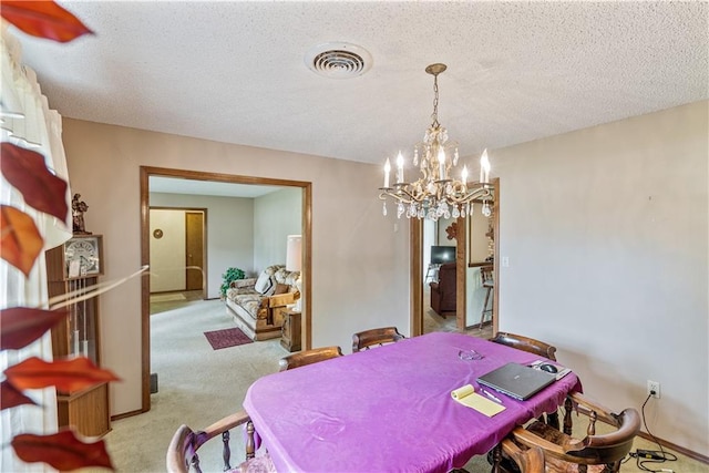 carpeted dining space with a textured ceiling and an inviting chandelier