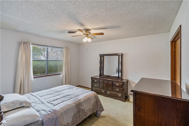 bedroom featuring ceiling fan, a textured ceiling, and carpet flooring