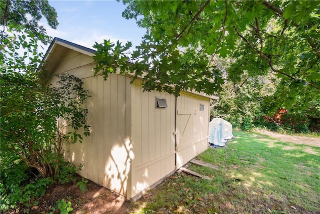 view of property exterior featuring a shed and a yard