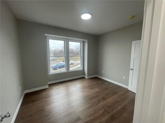 empty room with dark hardwood / wood-style floors