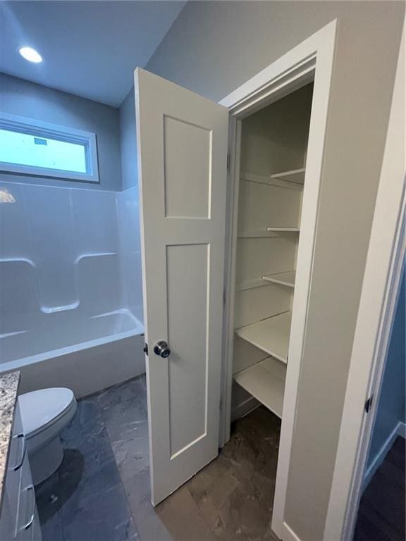 full bathroom with vanity, tub / shower combination, and toilet