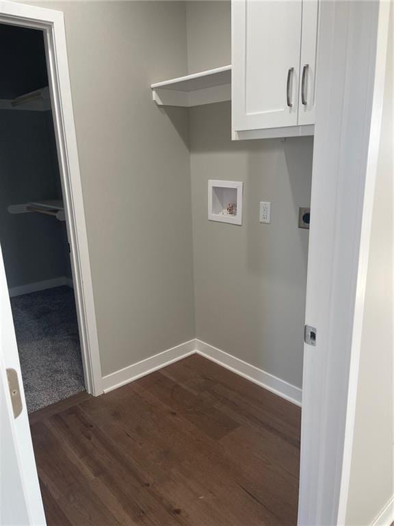 clothes washing area featuring washer hookup, cabinets, dark hardwood / wood-style floors, and electric dryer hookup