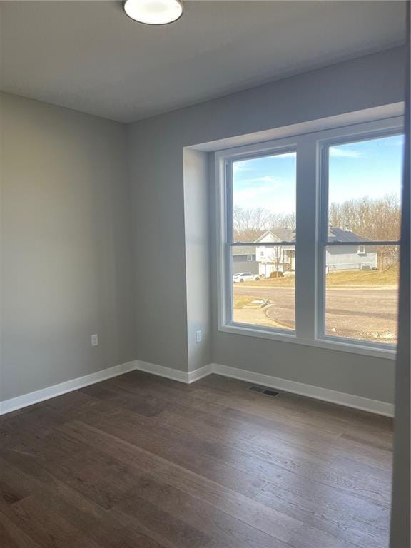 spare room with dark hardwood / wood-style flooring