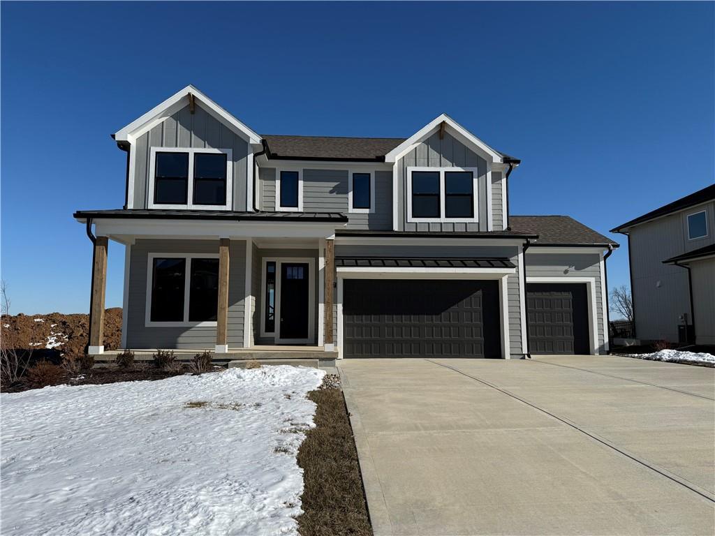 view of front of property featuring a garage and a porch