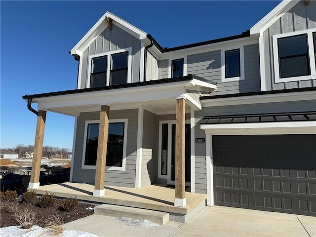 view of front of house with covered porch and a garage