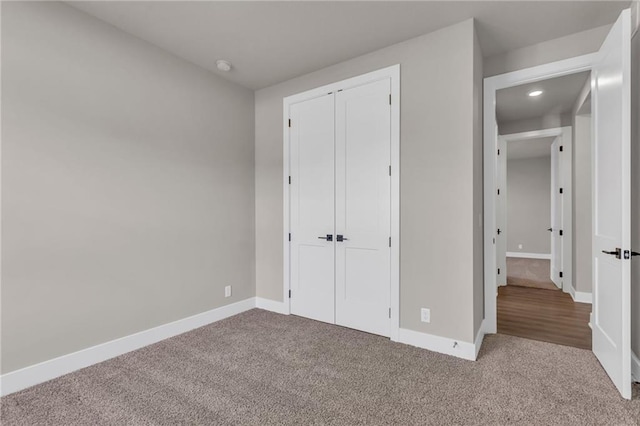 unfurnished bedroom with carpet flooring and a closet