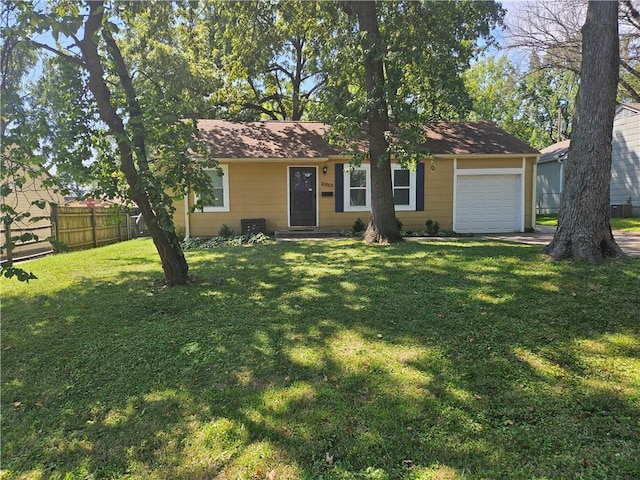 ranch-style house featuring a front yard and a garage