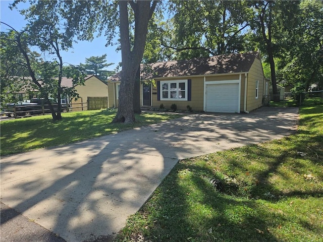 ranch-style home with a garage and a front yard