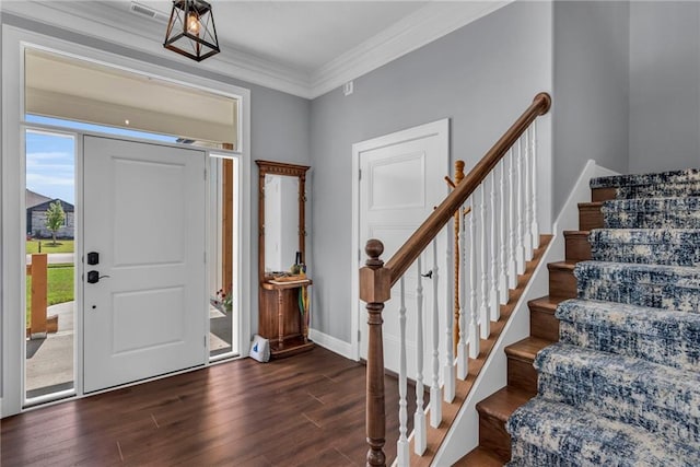 foyer with dark hardwood / wood-style floors and ornamental molding