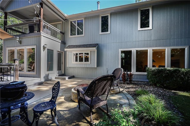 rear view of house with a patio area and a balcony