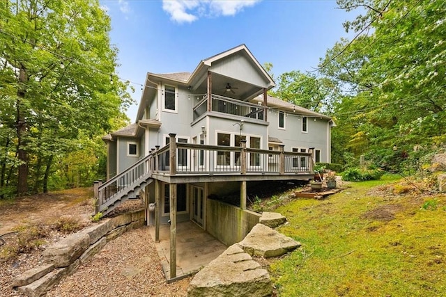 back of house with ceiling fan and a deck