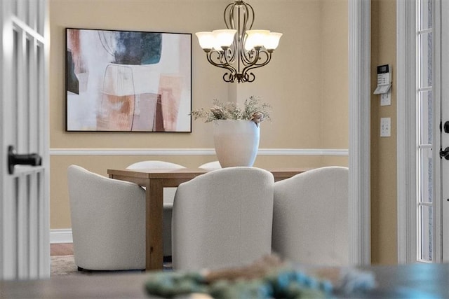 dining area featuring an inviting chandelier