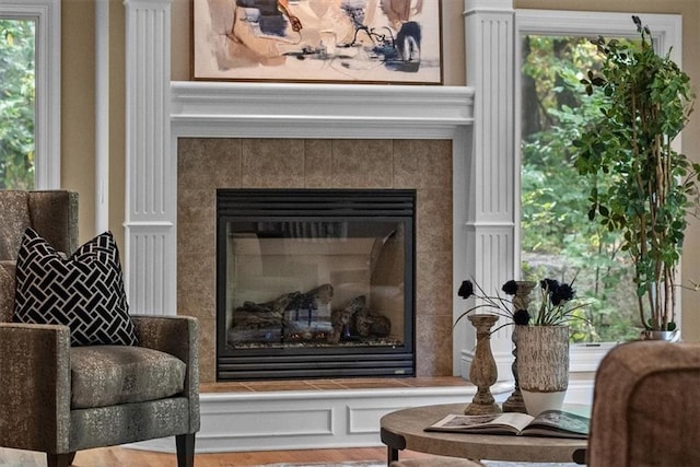 living area featuring hardwood / wood-style floors and a tile fireplace