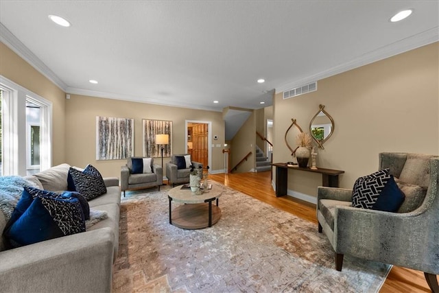 living room featuring hardwood / wood-style flooring and crown molding