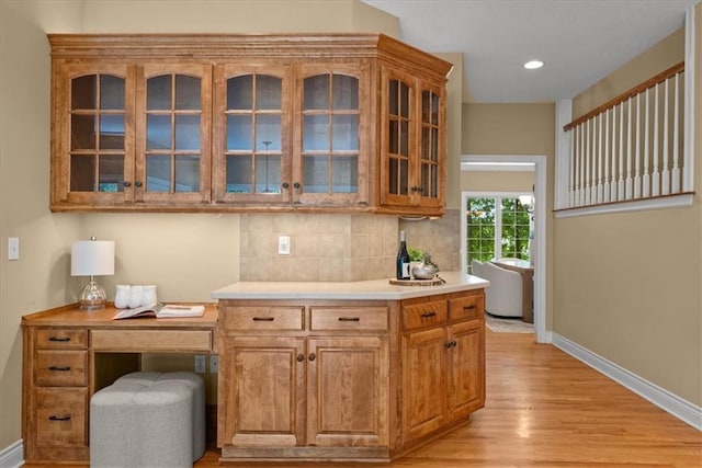 interior space featuring tasteful backsplash and light hardwood / wood-style floors