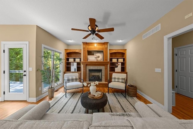 living room featuring light hardwood / wood-style flooring and ceiling fan