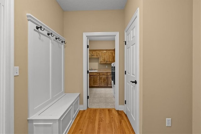 mudroom featuring light hardwood / wood-style floors and sink