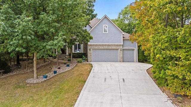 obstructed view of property with a front yard and a garage