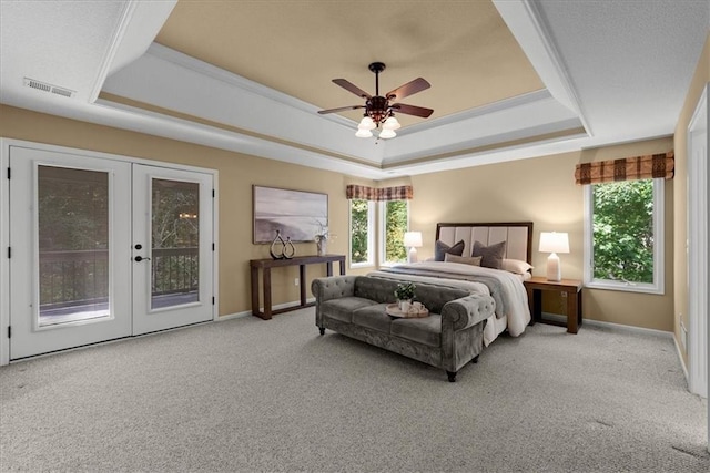 carpeted bedroom featuring french doors, access to outside, a raised ceiling, and ceiling fan