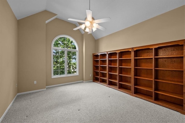 spare room featuring ceiling fan, carpet floors, and vaulted ceiling