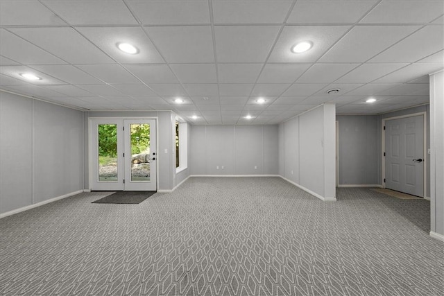 basement with a drop ceiling and light colored carpet