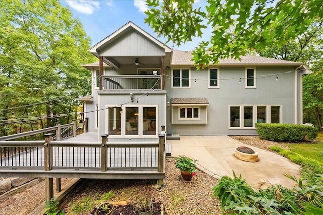 rear view of property with a patio, a deck, an outdoor fire pit, and ceiling fan