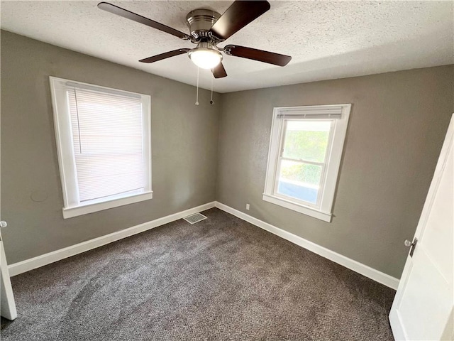 carpeted empty room featuring a textured ceiling and ceiling fan