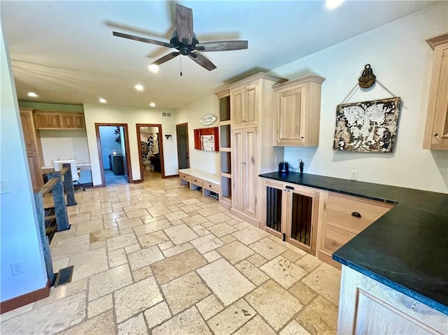 kitchen featuring ceiling fan and light brown cabinetry