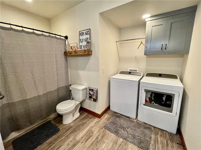 laundry room featuring light hardwood / wood-style floors and washing machine and dryer