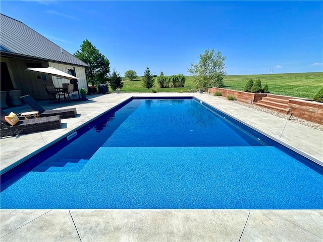 view of swimming pool with a yard and a patio area