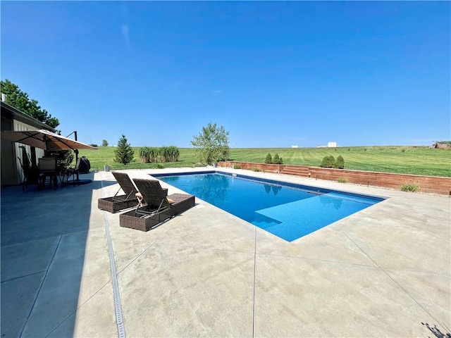 view of swimming pool featuring a yard and a patio