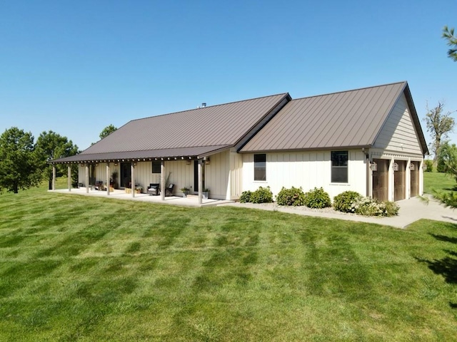 back of house with a lawn and a patio area