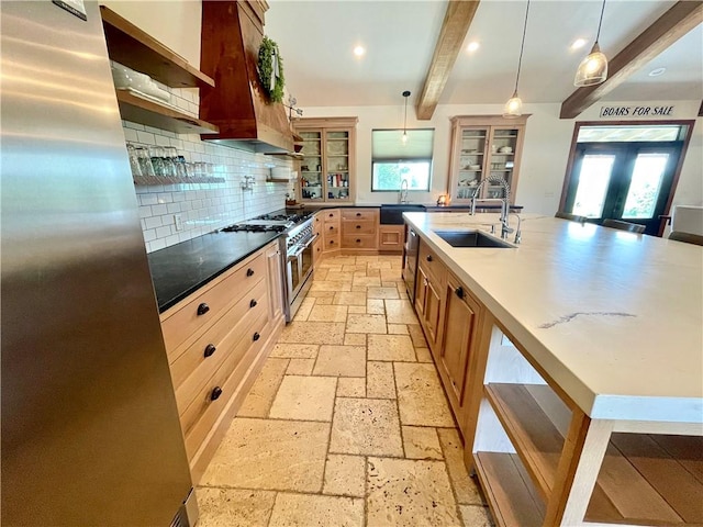 kitchen with pendant lighting, stainless steel appliances, beam ceiling, and a healthy amount of sunlight