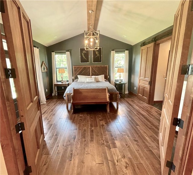 bedroom with vaulted ceiling and hardwood / wood-style floors