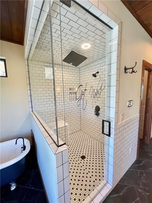 bathroom featuring shower with separate bathtub and tile walls