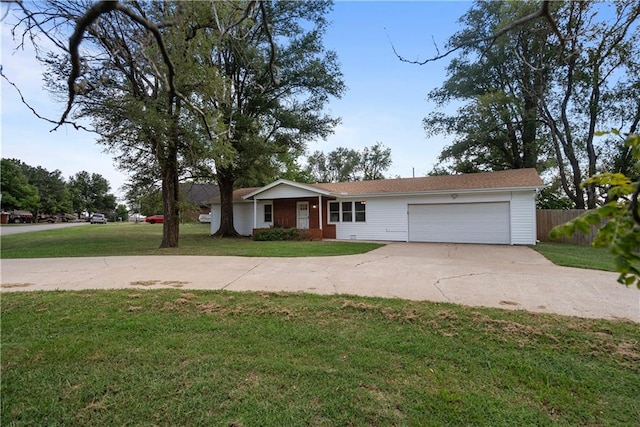 ranch-style home featuring a garage and a front lawn