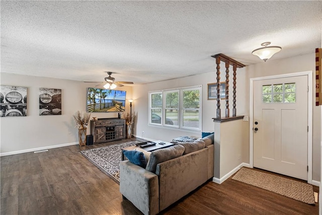 living room featuring a textured ceiling, plenty of natural light, ceiling fan, and dark hardwood / wood-style floors