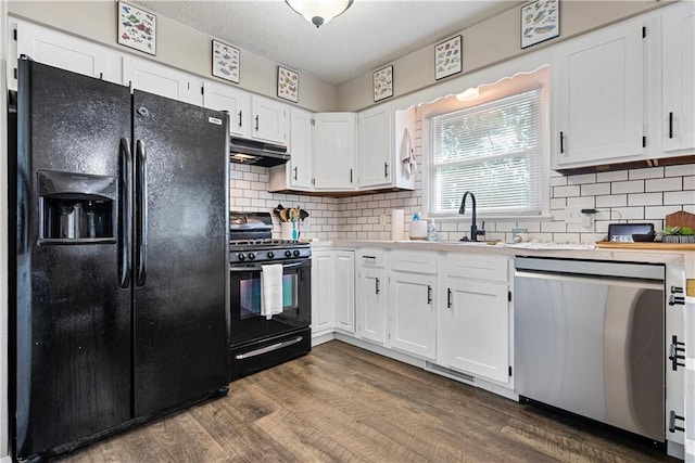 kitchen featuring black appliances, tasteful backsplash, dark hardwood / wood-style floors, and white cabinetry