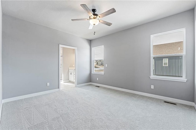 unfurnished room with light carpet and ceiling fan