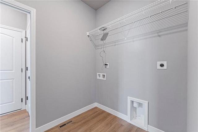 laundry room with wood-type flooring, hookup for an electric dryer, and hookup for a washing machine