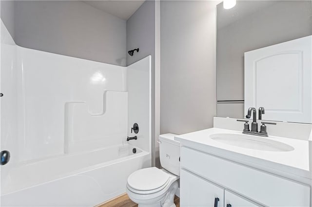 full bathroom featuring vanity, hardwood / wood-style floors, toilet, and shower / bath combination