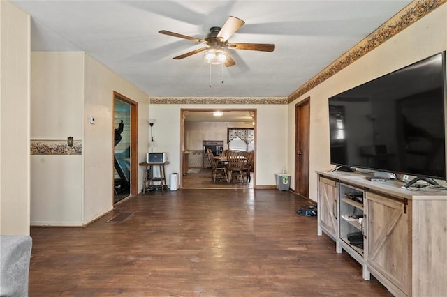 interior space featuring ceiling fan and dark hardwood / wood-style flooring