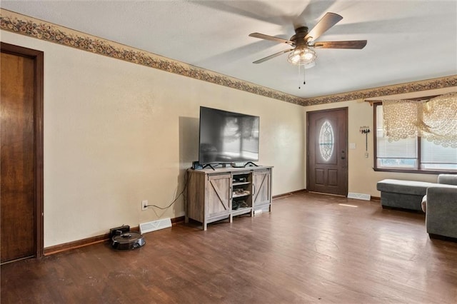 interior space featuring dark wood-type flooring and ceiling fan